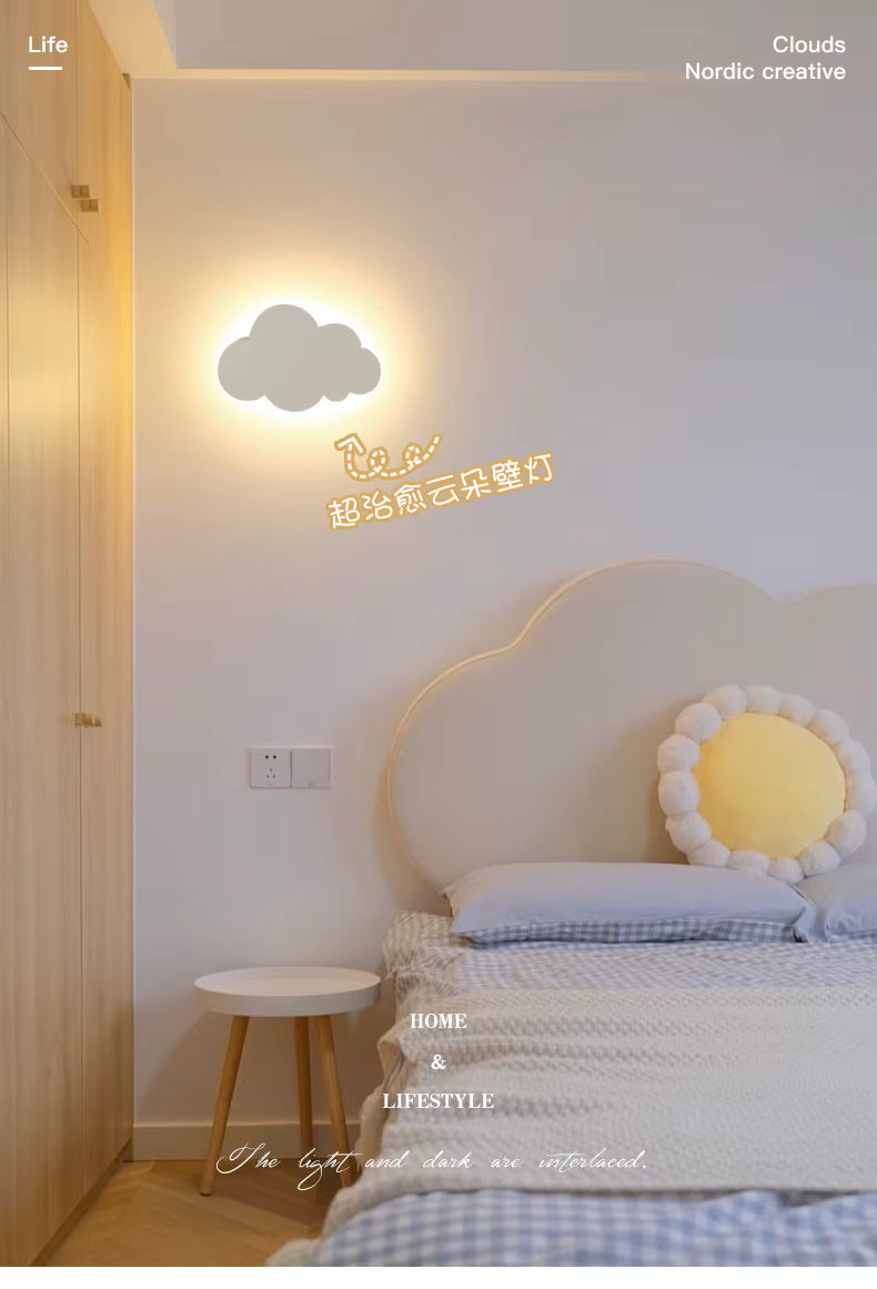 Children's bedroom with cloud-shaped wall light and decorative headboard.